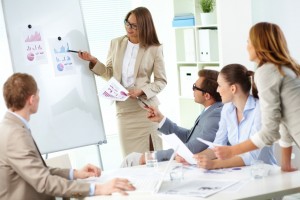 Confident businesswoman explaining her ideas to colleagues at meeting