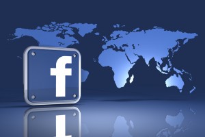 3d illustration of a facebook logo standing in front of an upright map of the world on a blue reflective surface